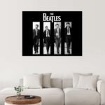 Vintage Beatles music wall art hanging above a vinyl record player in a modern living room.