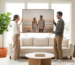 Newlyweds hanging a large custom wedding portrait on their living room wall.